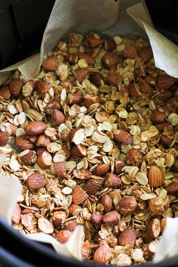 cooked granola in an air fryer basket.