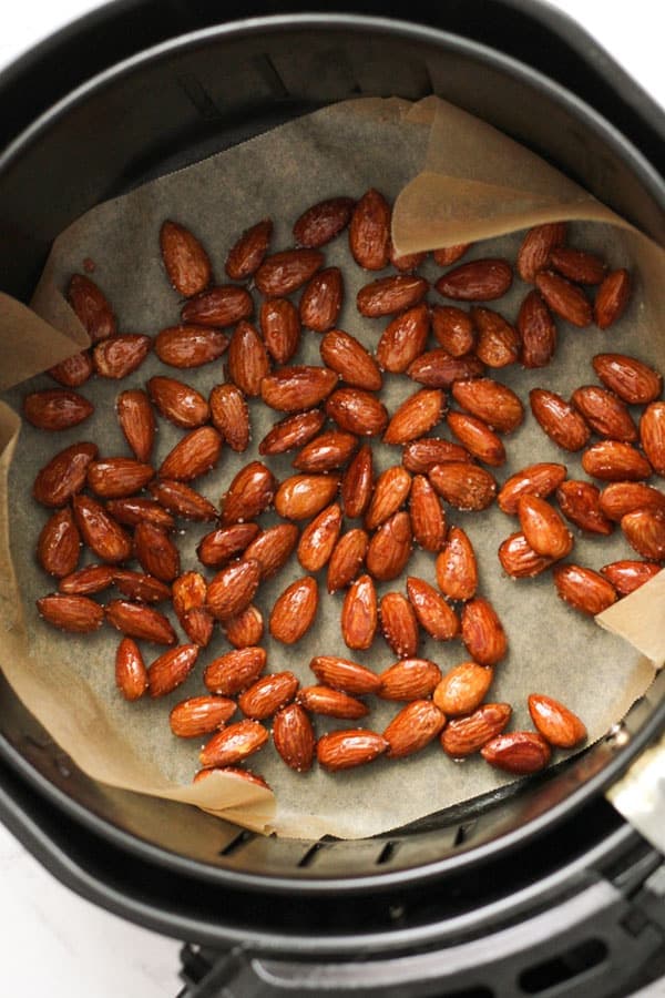 almonds in an air fryer basket.