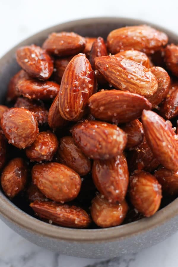 roasted almonds in a grey bowl.