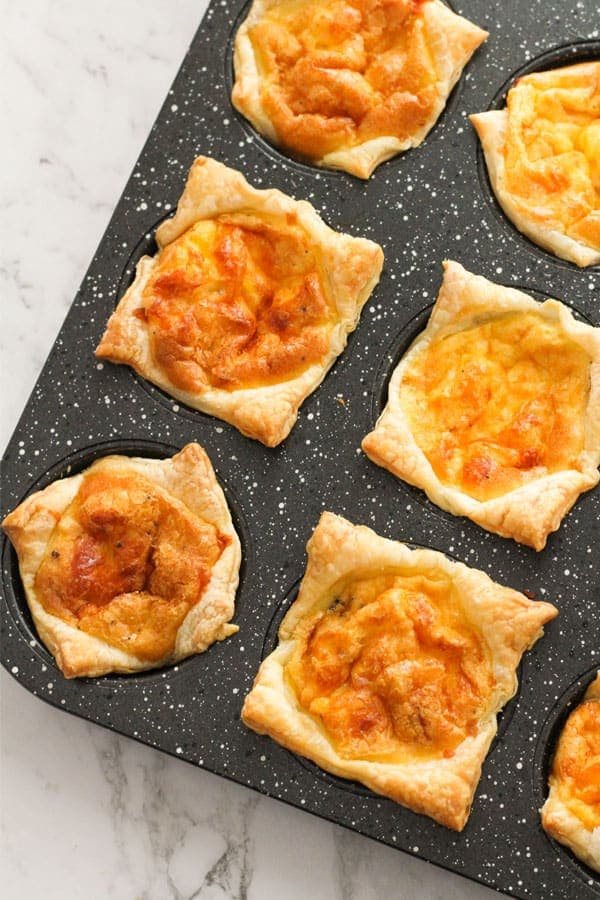 egg and bacon mini pies in a muffin tray.