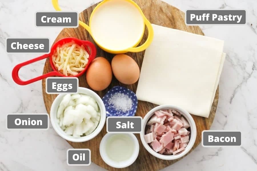 bacon egg pie ingredients on a wooden board.