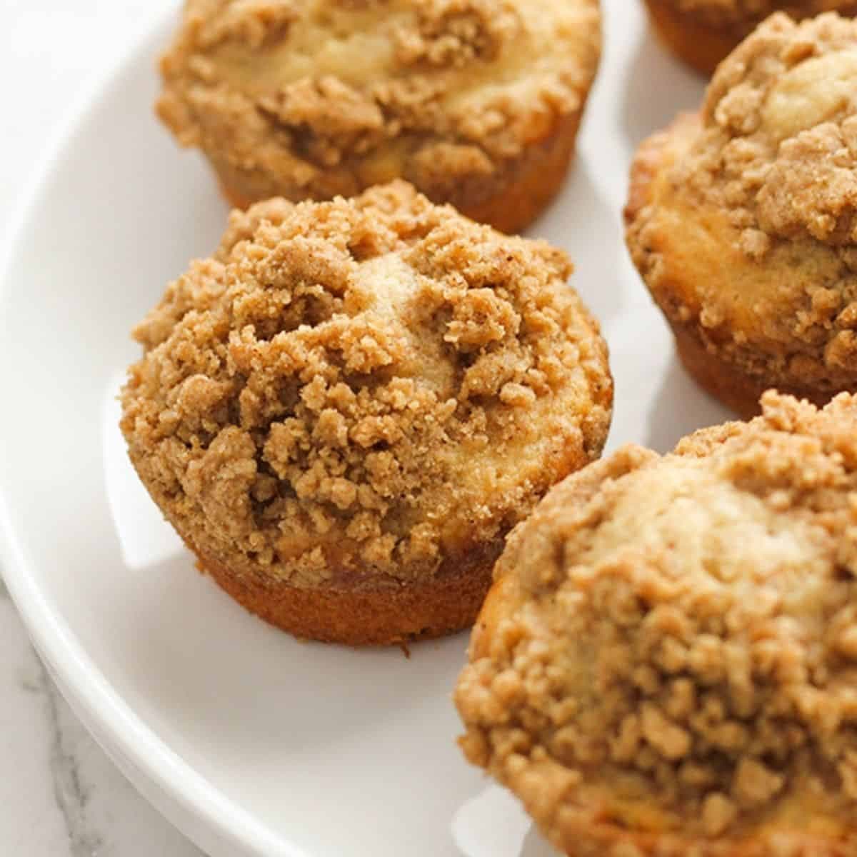 cinnamon muffins on a white plate.