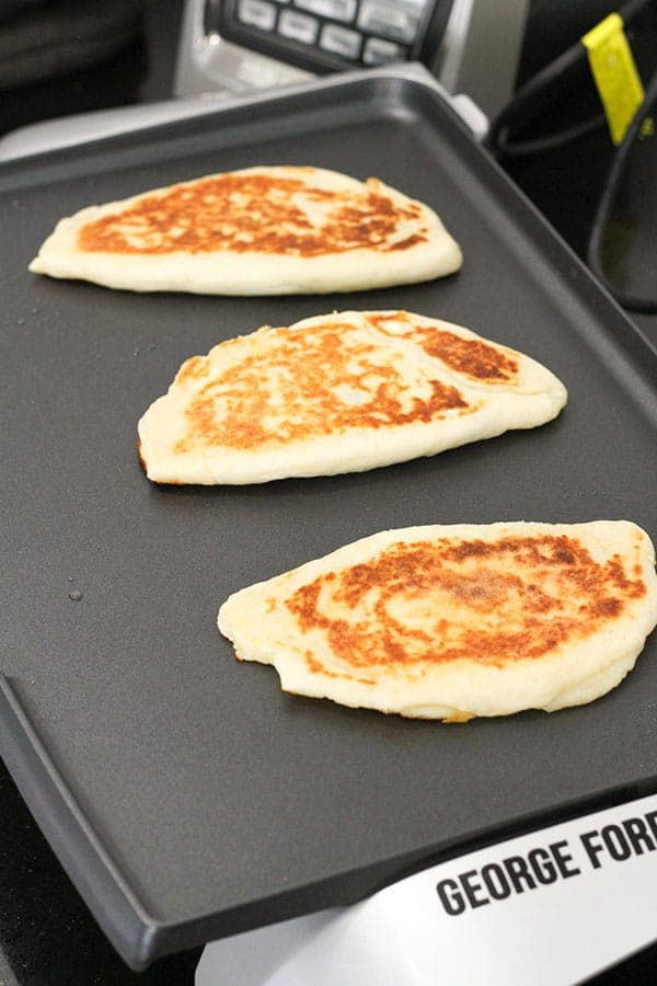 gozleme cooking on an electric griddle.