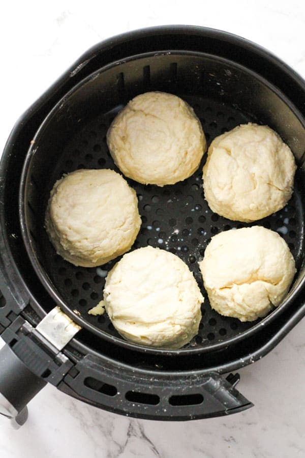scones in the air fryer basket ready to be cooked.