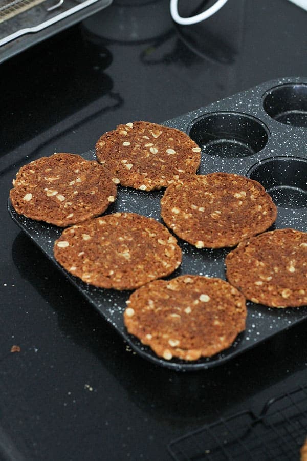 biscuits laying on top of a muffin tin.