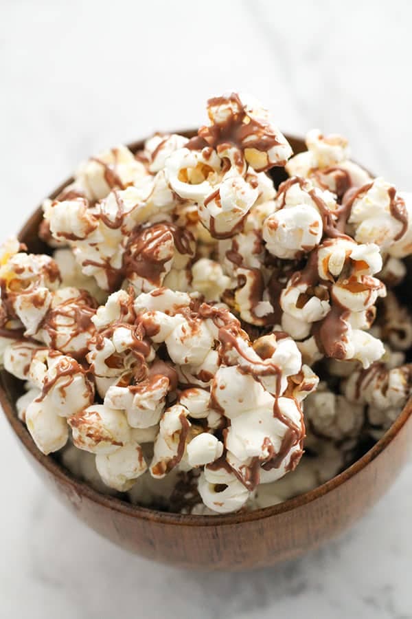 chocolate drizzled popcorn in a bowl.