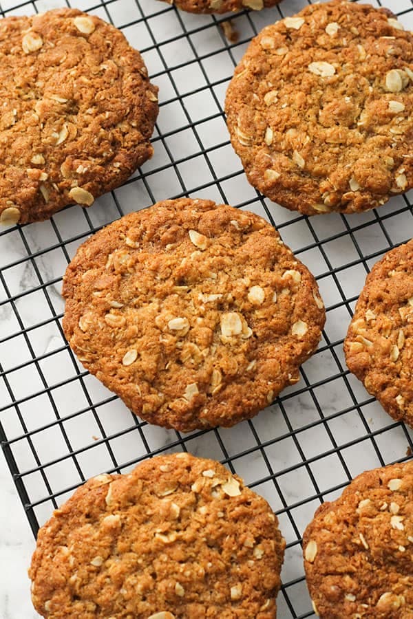 crunchy anzac biscuits on a wire rack.