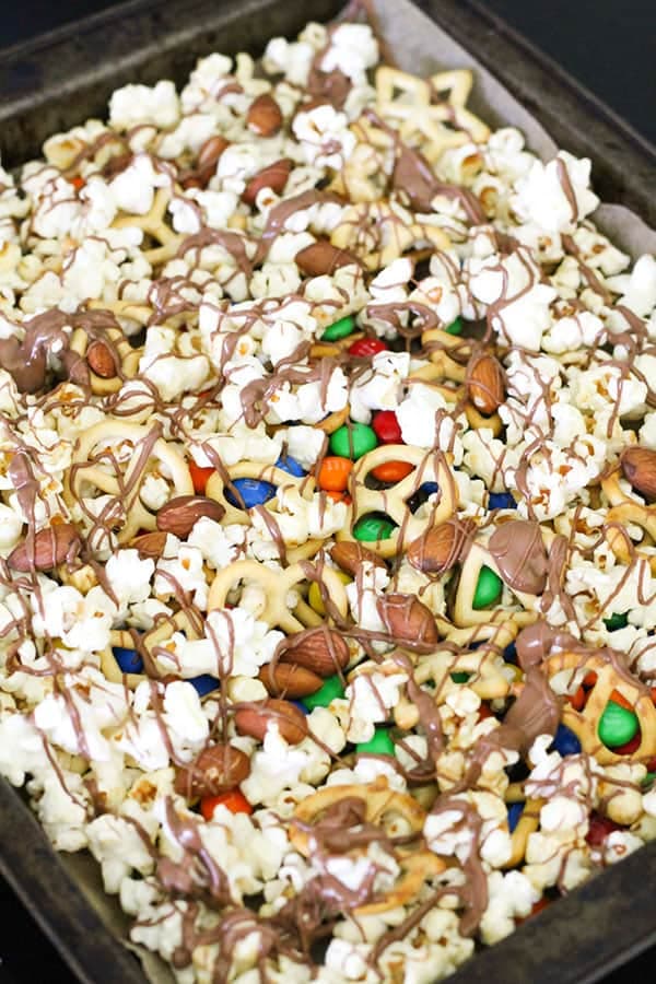 popcorn on a baking tray drizzled with chocolate..