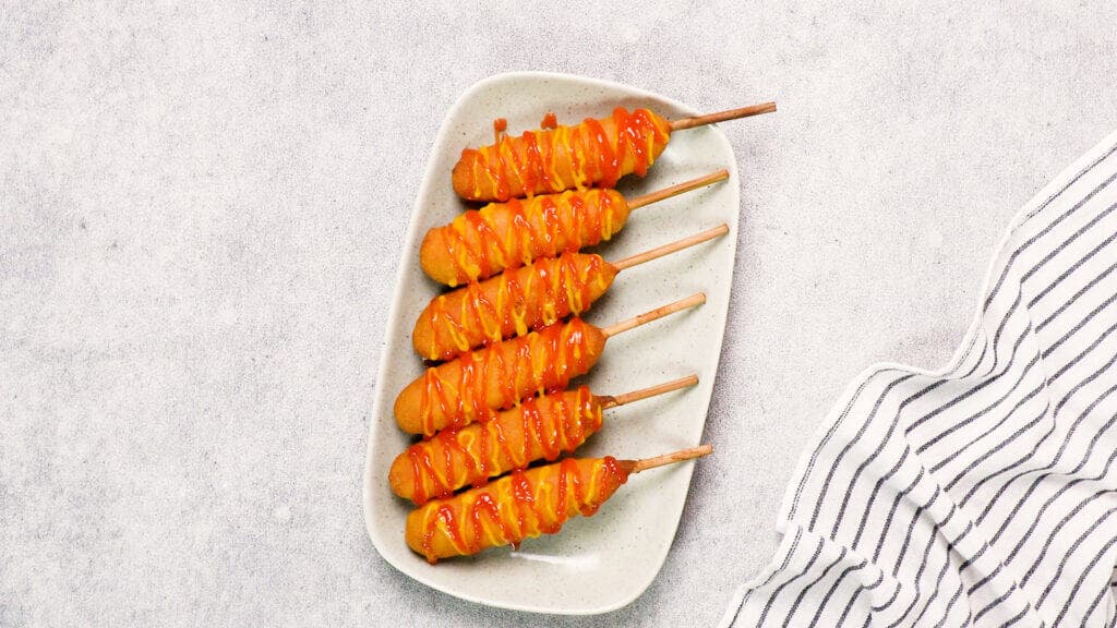 finished product with sauce and mustard on a grey plate