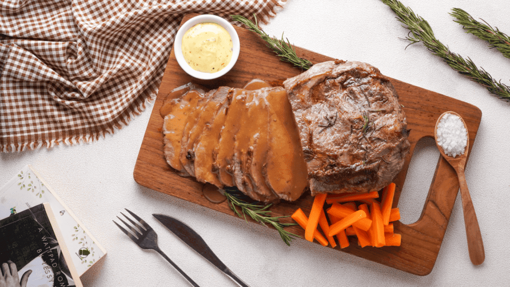 Roast Beef with veggies, gravy and mustard on a wooden coaster made with air fryer.