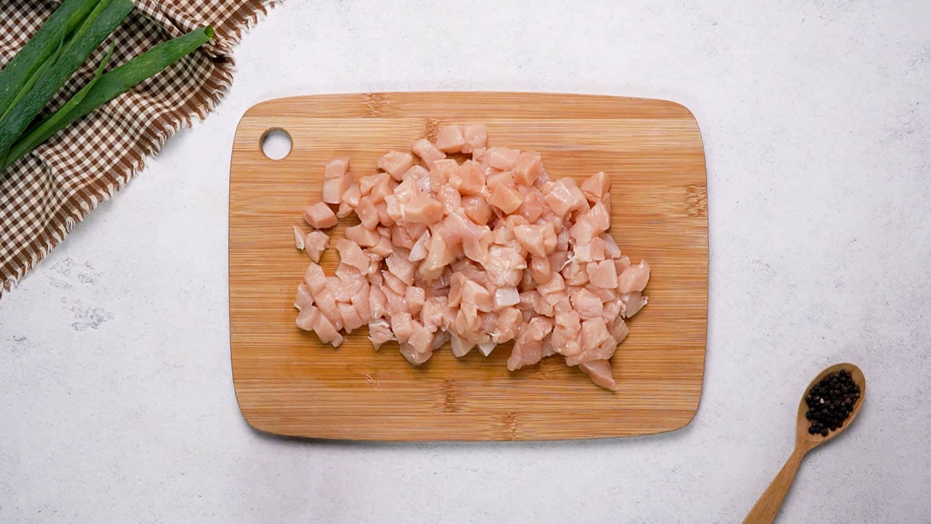 Start by dicing the raw chicken breasts into small bite-sized pieces. 