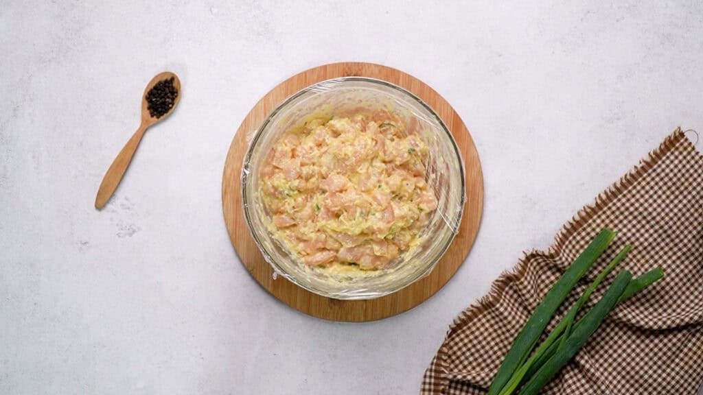 Mixture in mixing bowl cover with plastic wrap