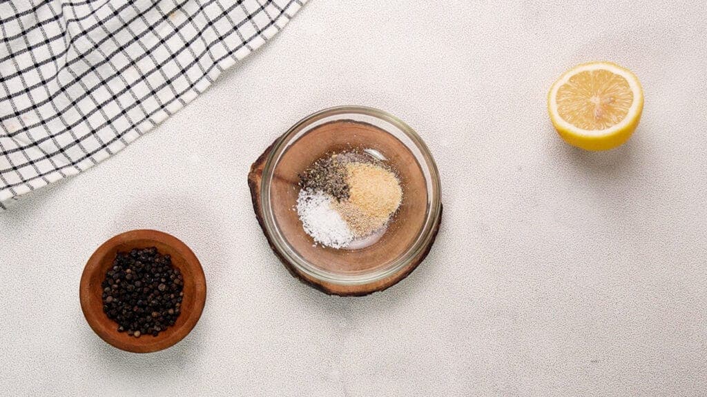 salt, ground white pepper, garlic and ground black pepper in small glass bowl