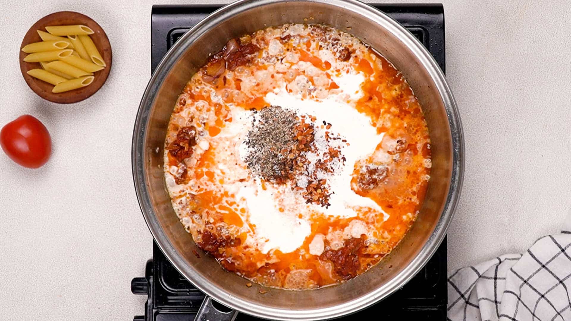 Stir in the heavy cream, chili flakes, salt, and black pepper, letting everything simmer together for about 3 minutes.<br/>