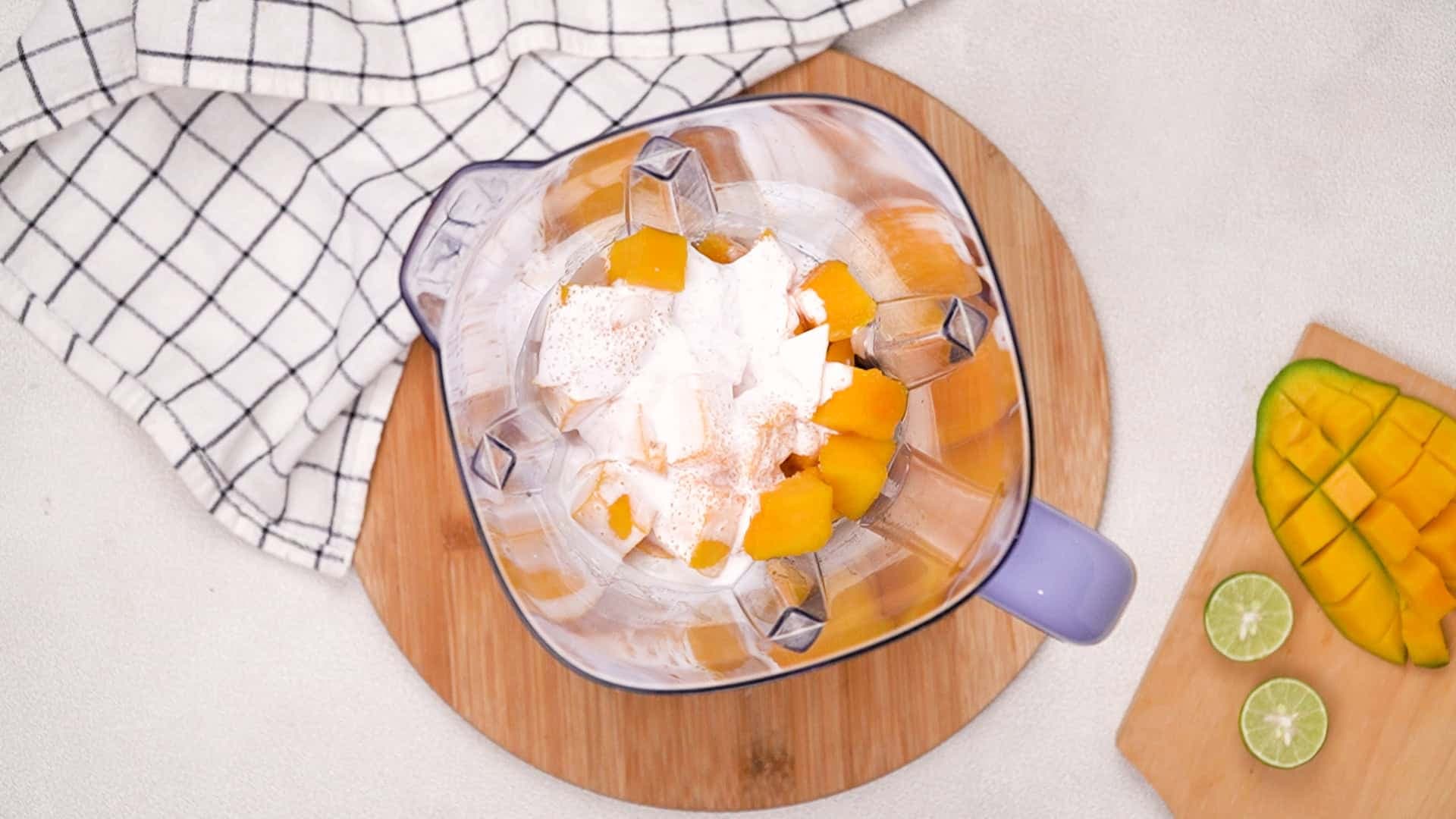 While you wait, combine mango flesh, white sugar, lime juice, and whipping cream in a blender or food processor.