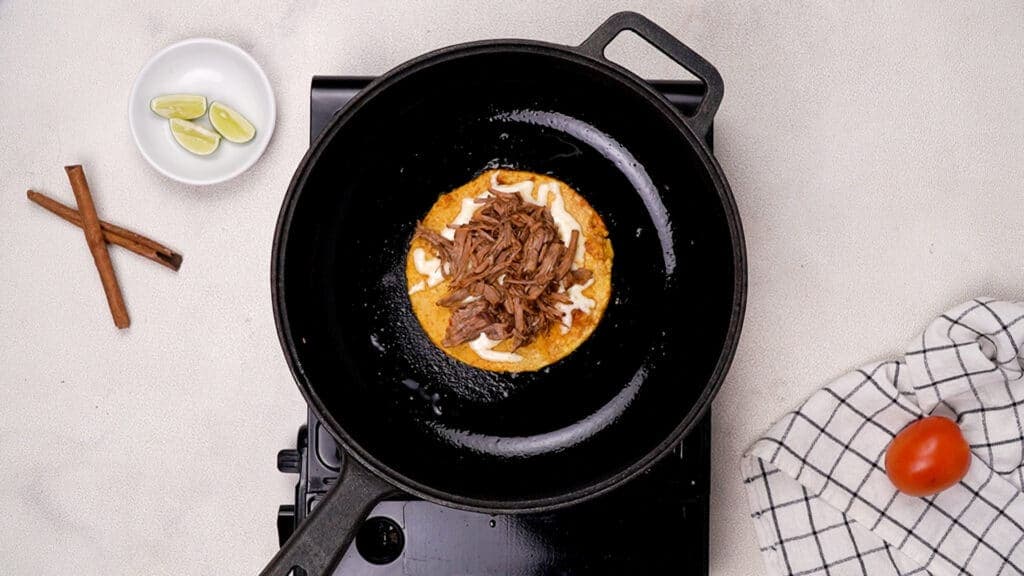 shredded meat and corn tortilla