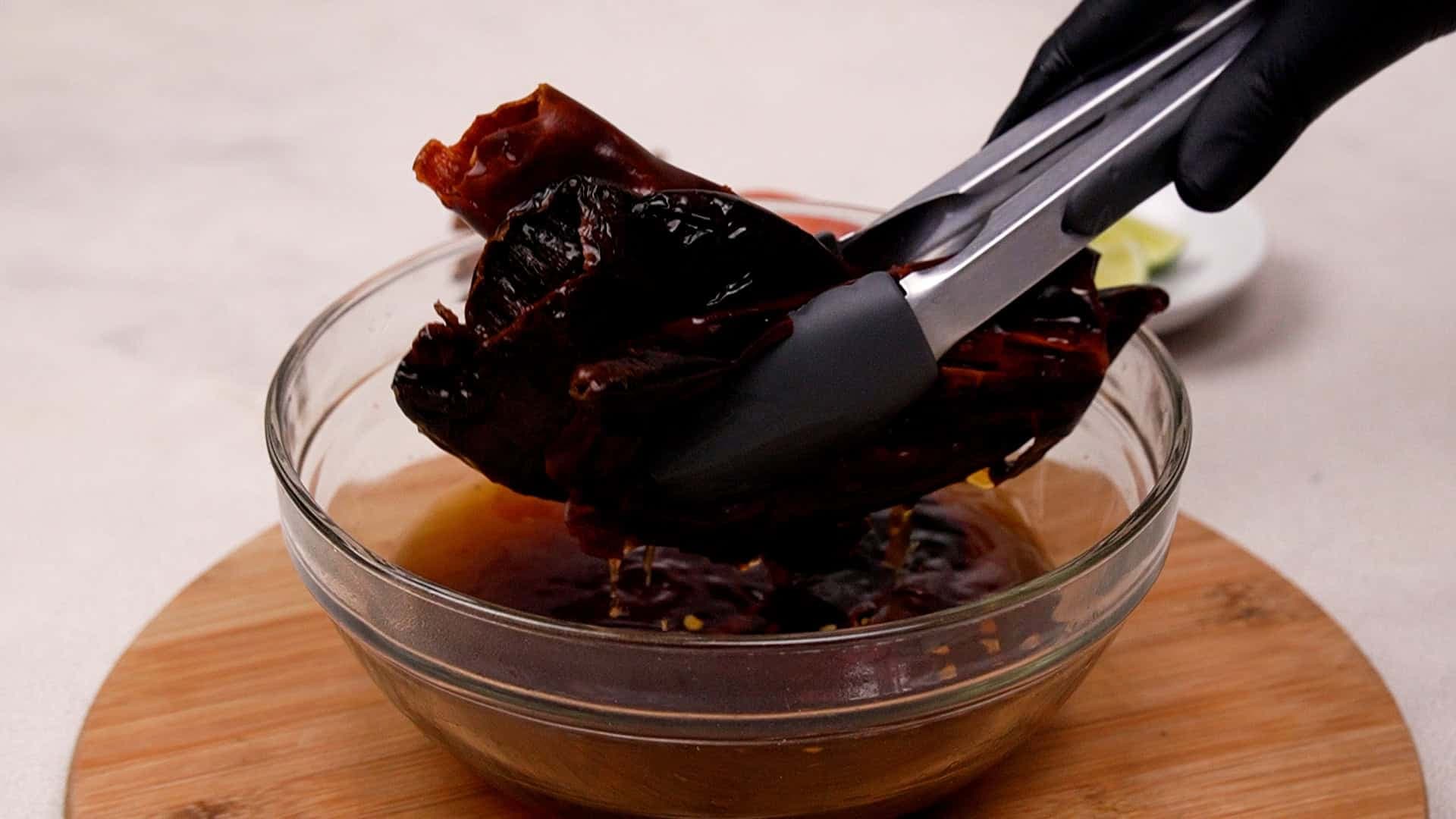 Once softened, remove the chiles and set aside the soaking water.