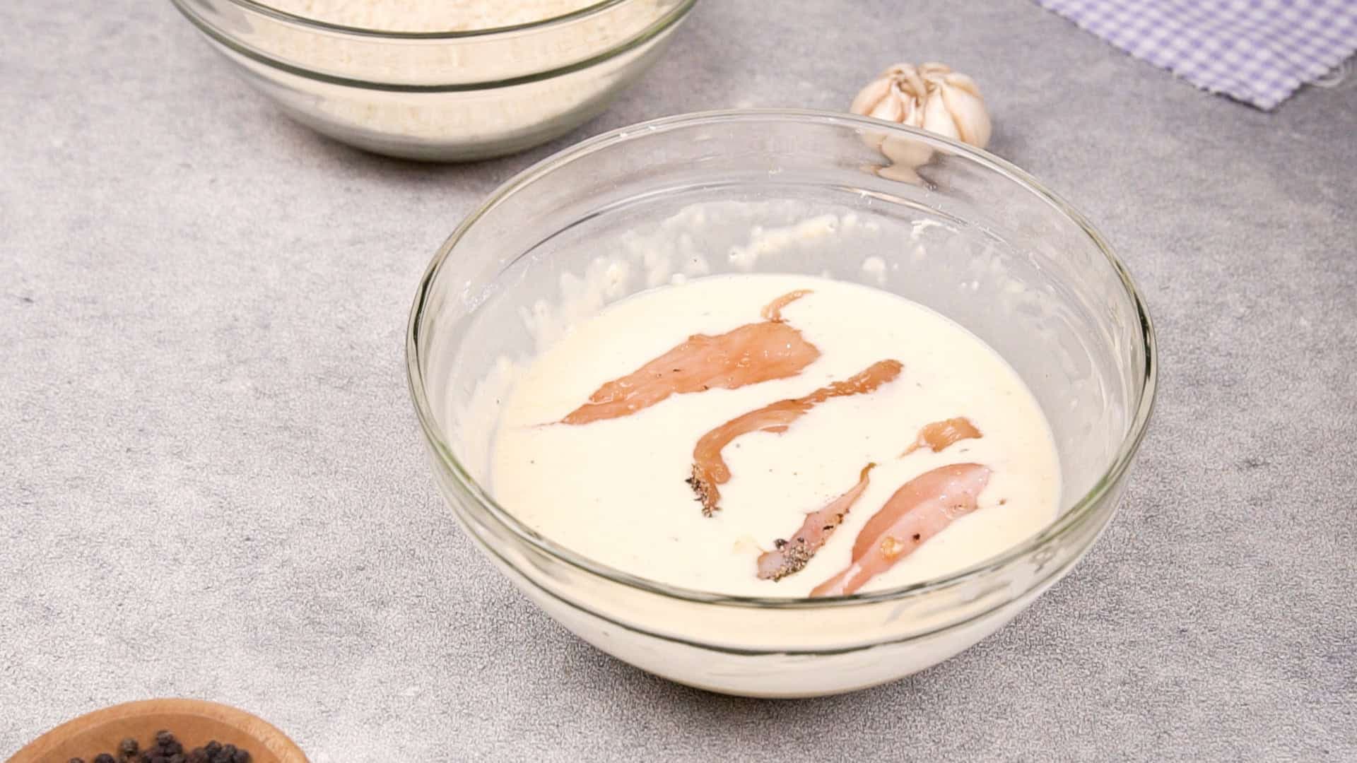 Dip each seasoned chicken strip into the batter, ensuring it's fully covered.