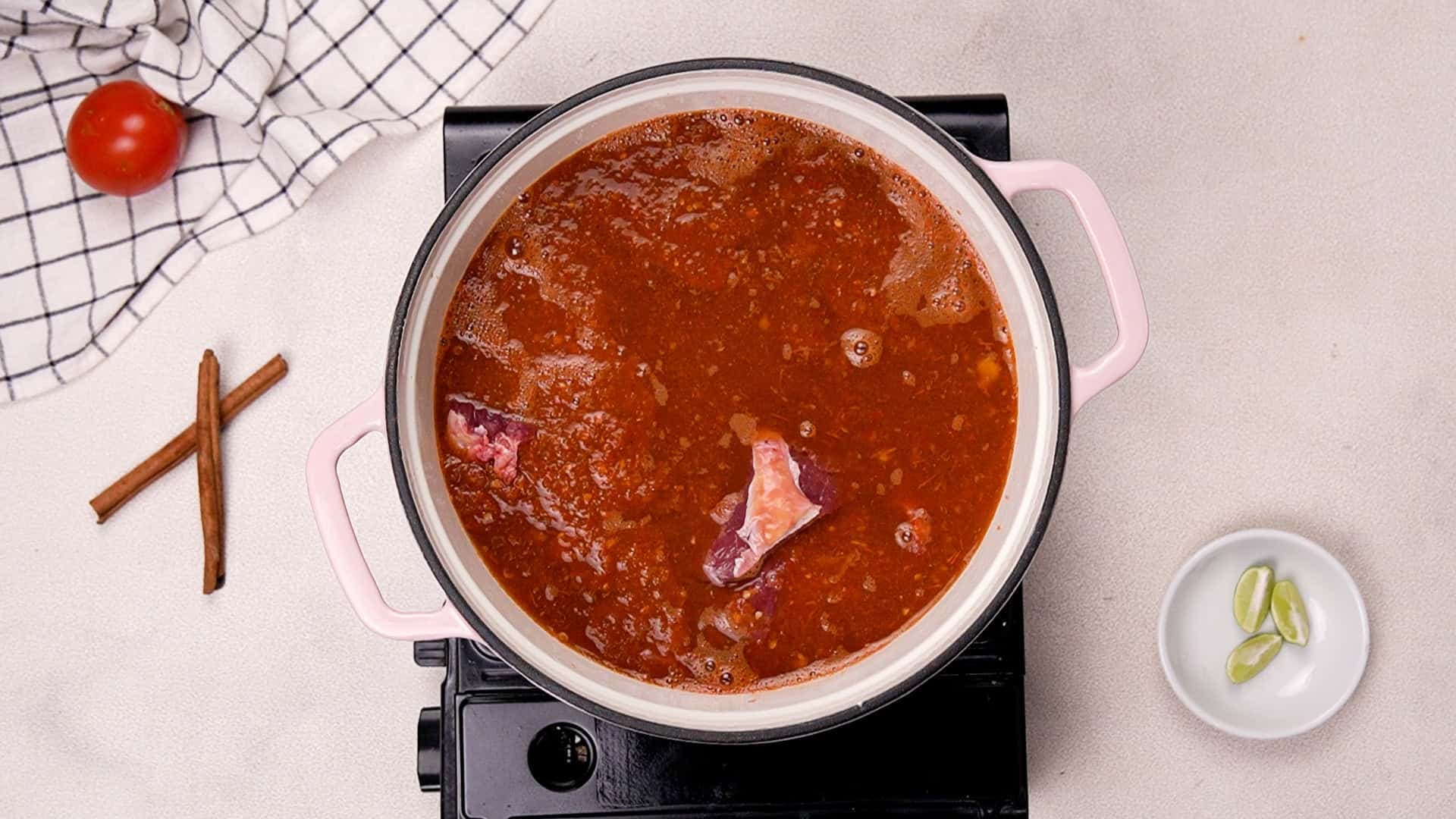 Next, heat a Dutch oven over medium heat. Add the beef, the blended sauce, and the beef stock.