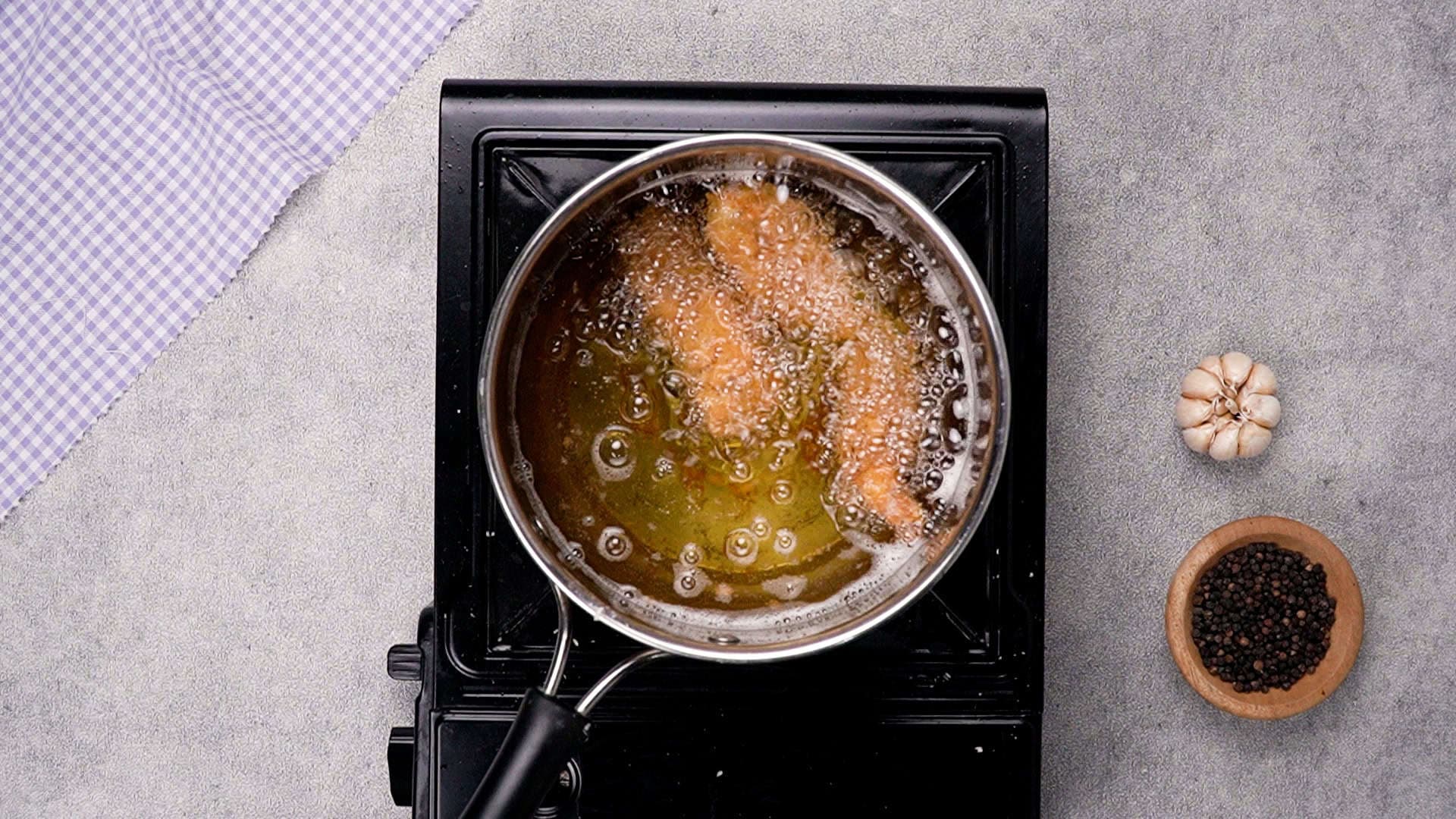 Fry a few pieces of chicken at a time to avoid overcrowding the pan.