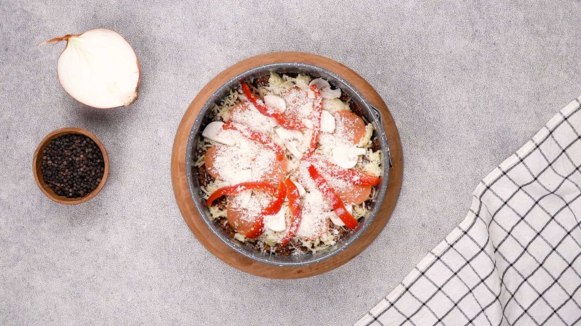 Finish by evenly distributing the grated Parmesan cheese over everything.