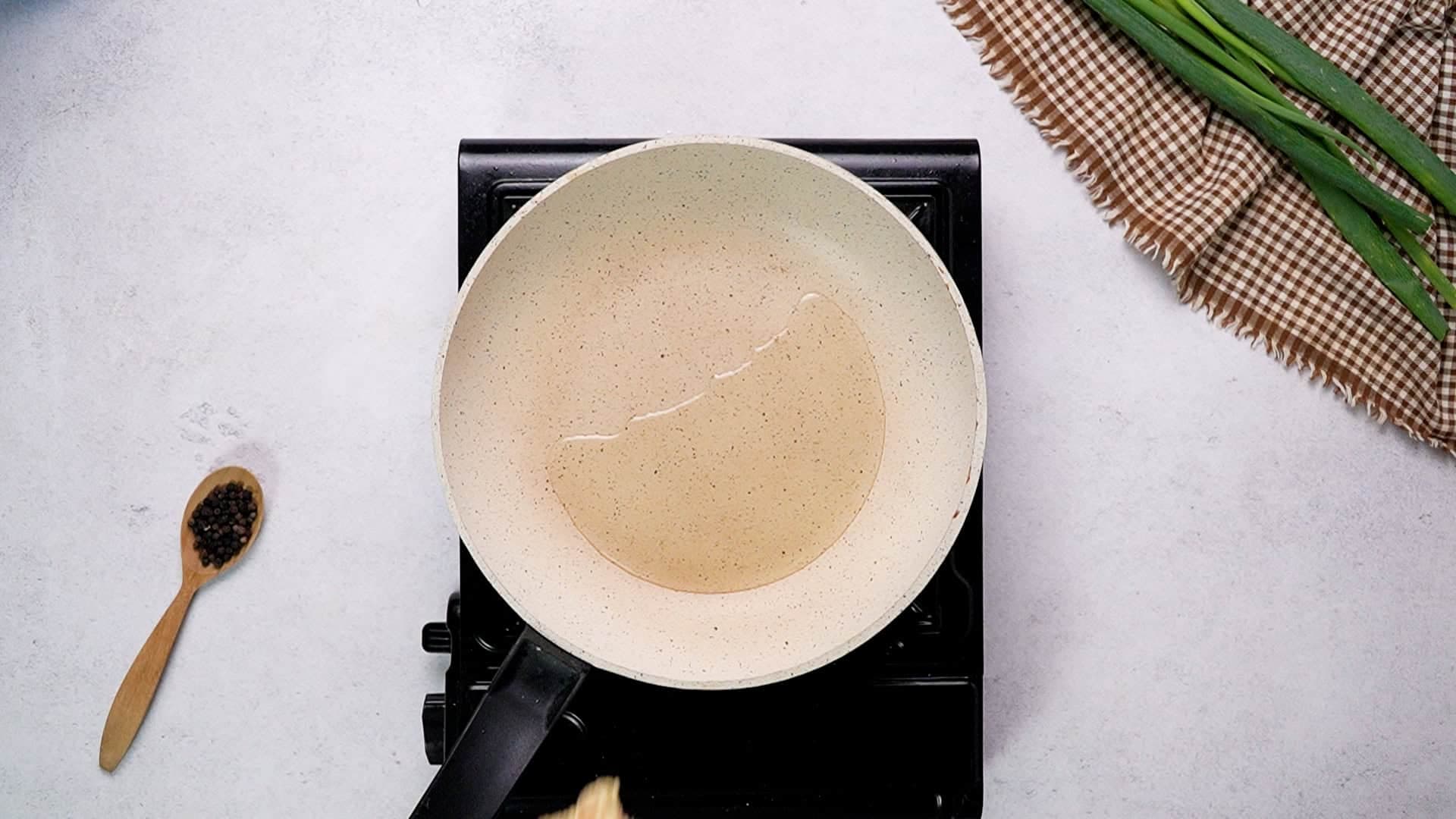 When you're ready to cook, heat a large non-stick pan over medium heat and add two tablespoons of olive oil.