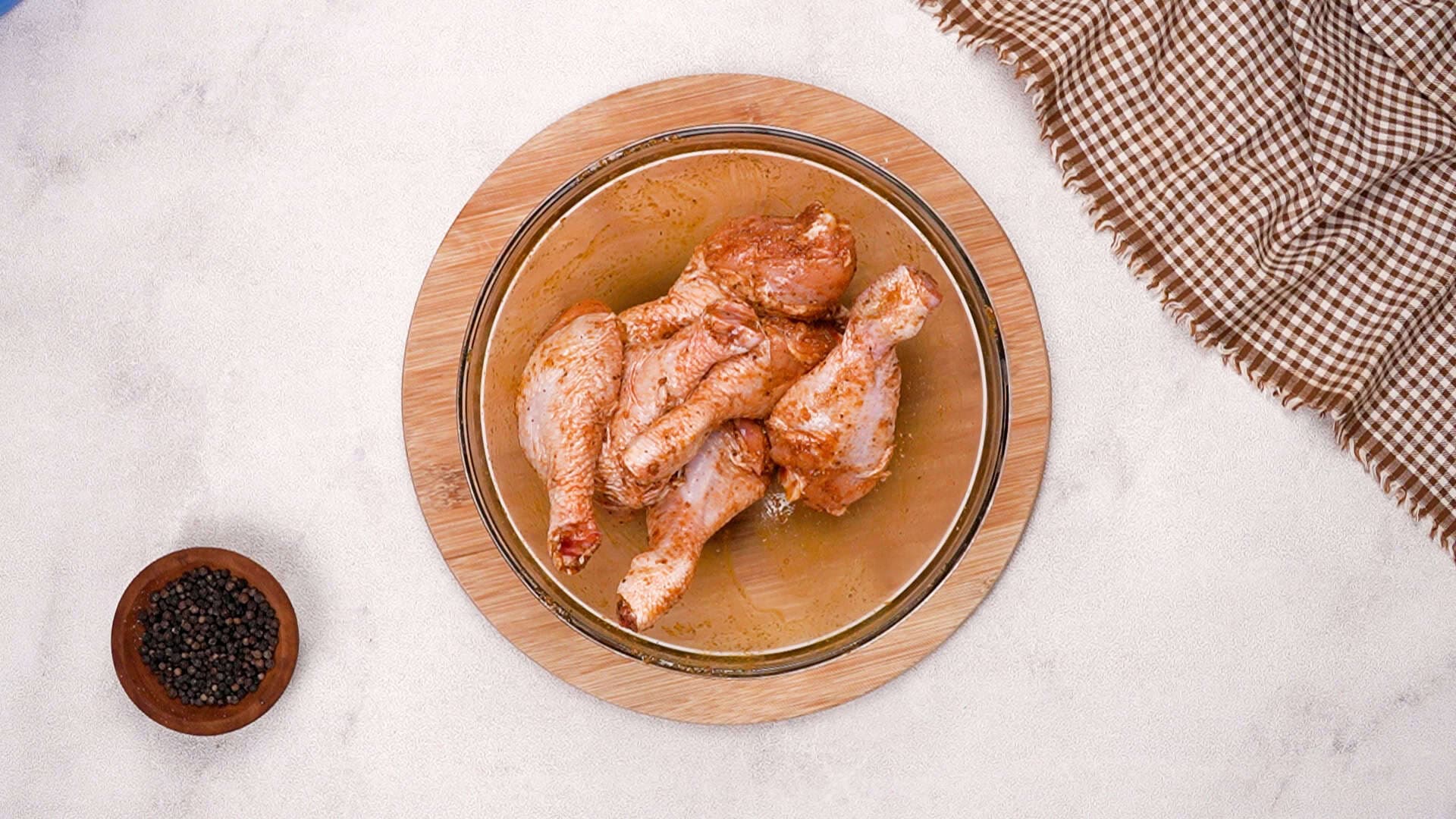 Add the drumsticks to the bowl and toss until they're fully coated in the seasoning mixture.
