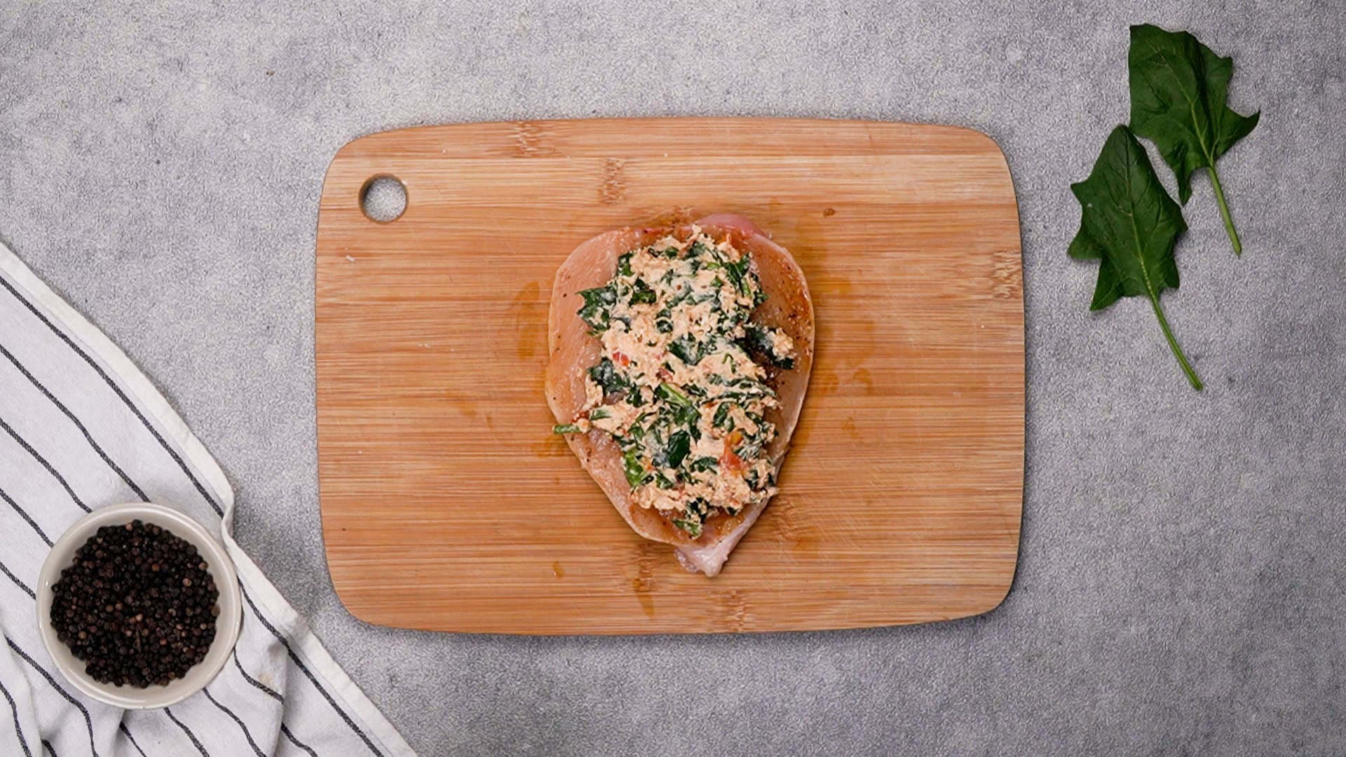 Spoon the filling into each chicken breast and stuff the chicken. Don't worry if a little spills out. Secure with toothpicks.