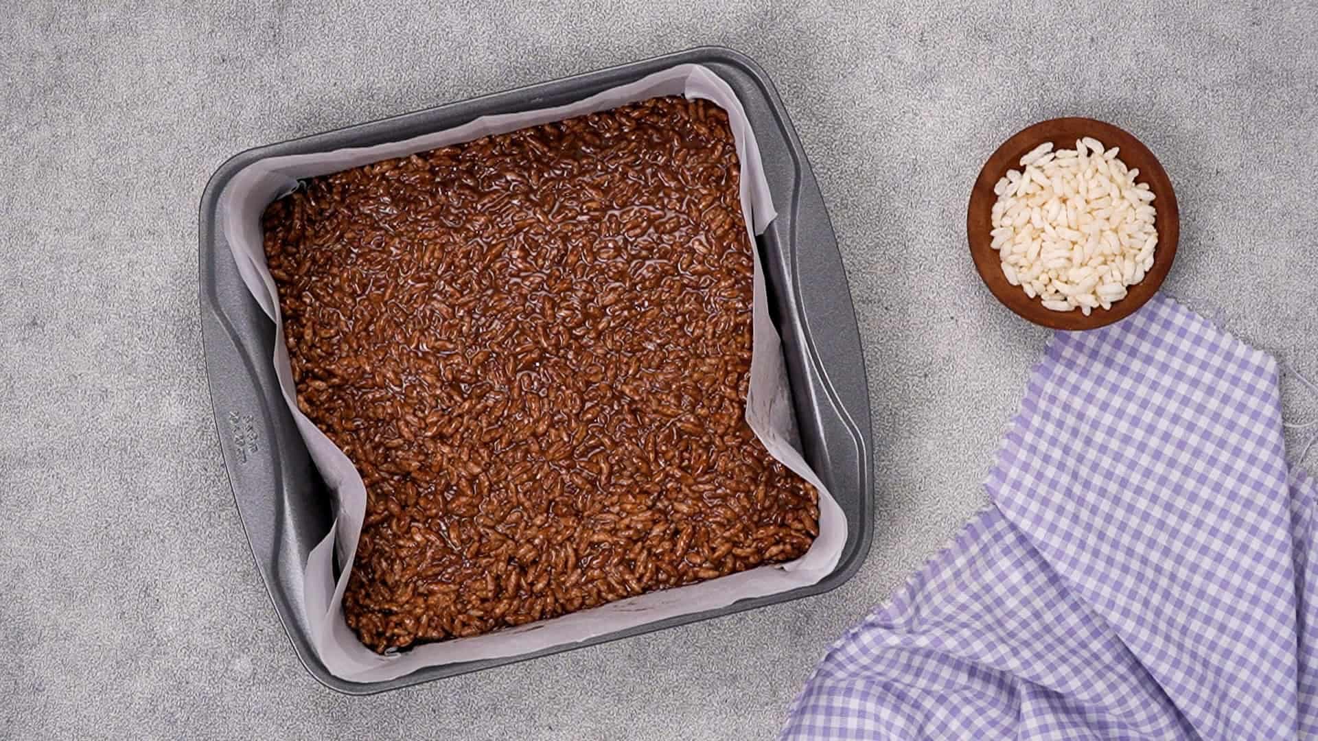 Transfer it to the prepared pan, pressing down gently to form a uniform layer about 1 inch thick.