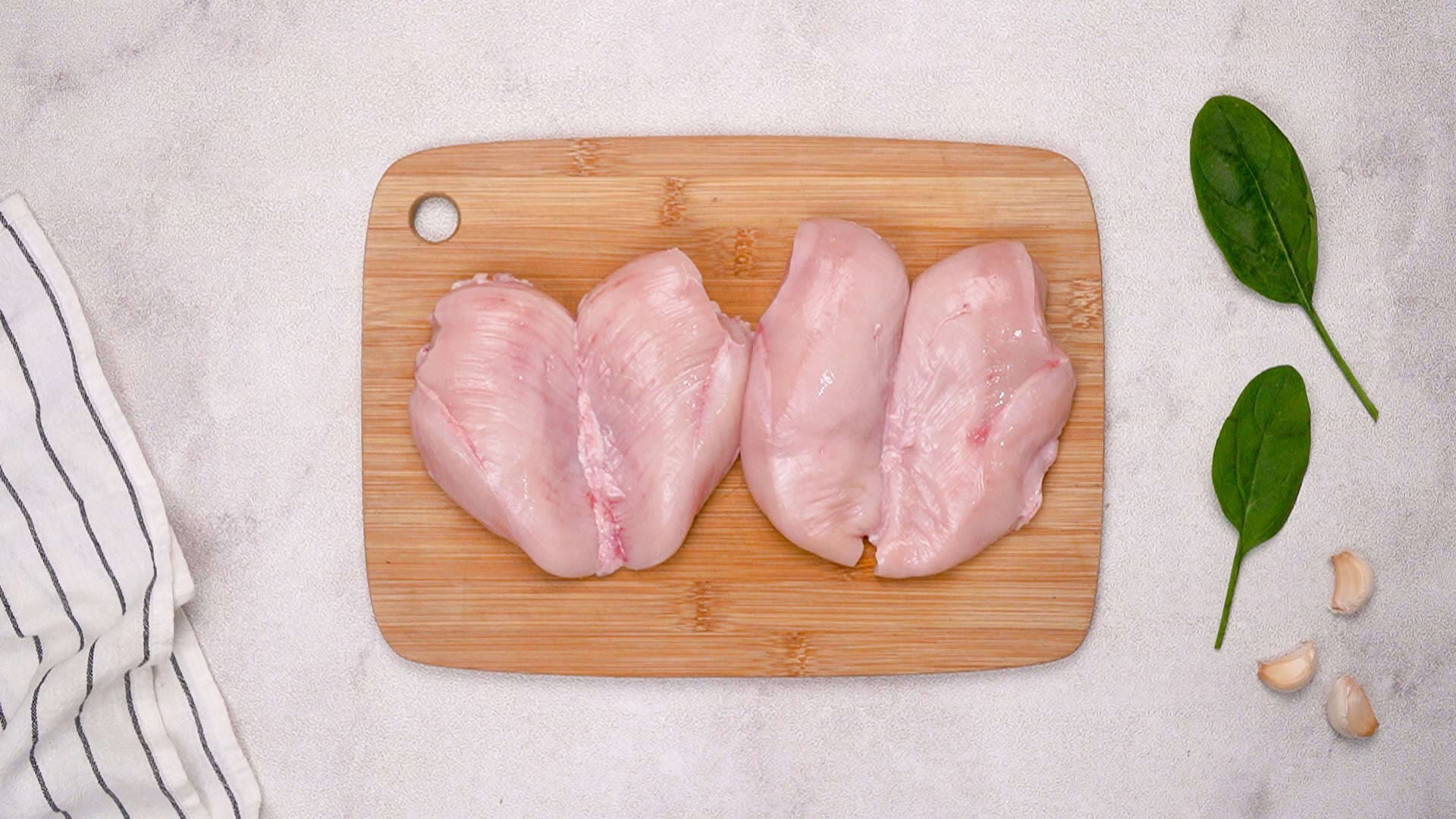 Start by slicing the chicken breasts in half horizontally to create thinner cutlets.