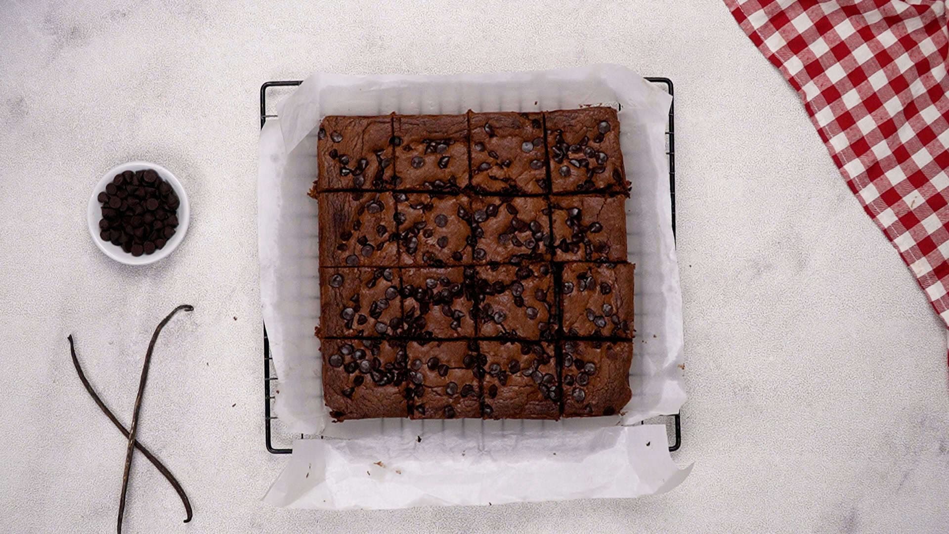 Let the brownies cool completely in the pan on a wire rack. Once they've cooled, use the parchment paper overhang to lift them out of the pan and cut them into squares. Enjoy!