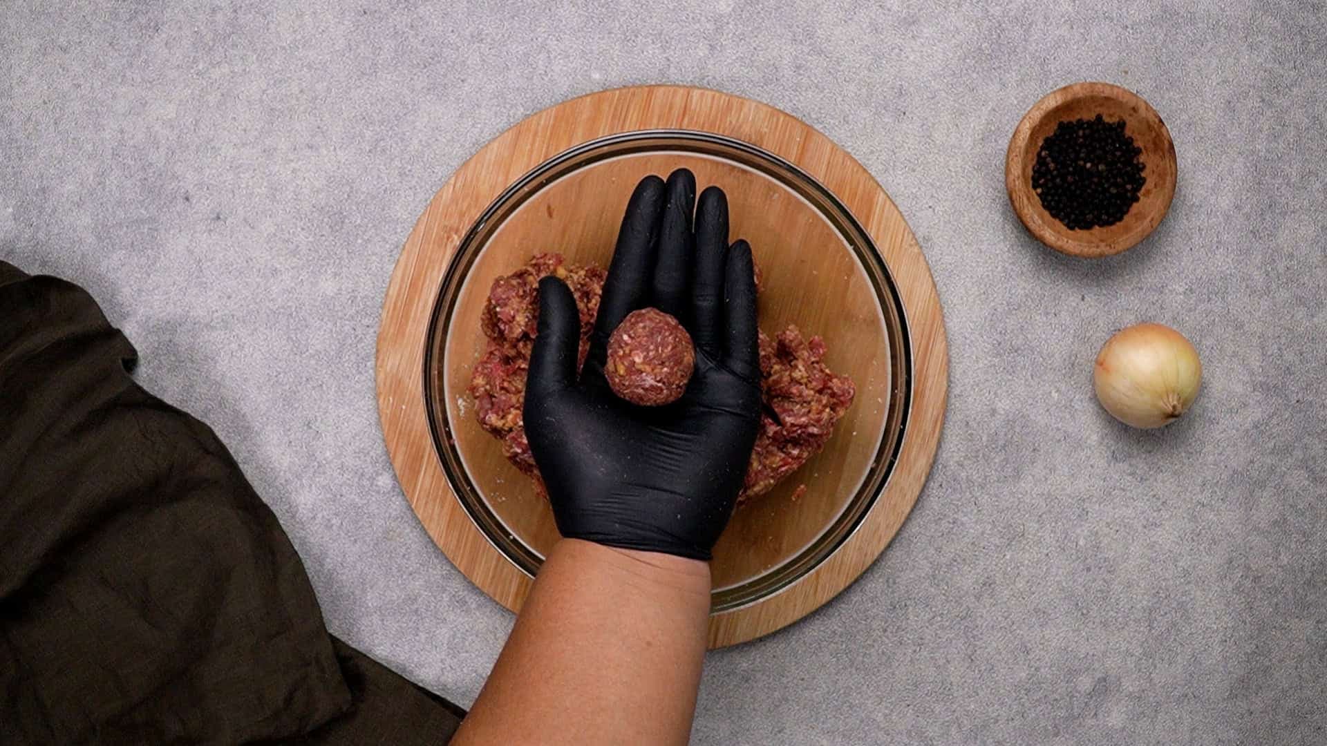 Next, wet your hands and shape the mixture into 16 evenly sized meatballs. Try to keep them uniform so they cook evenly.