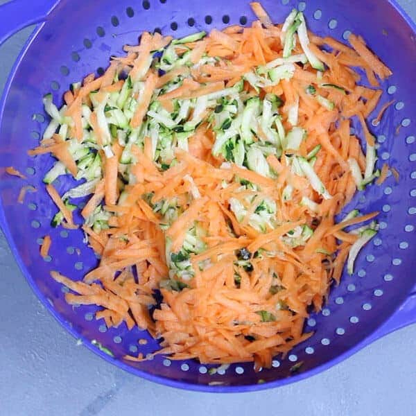 shredded carrot and zucchini in a colander