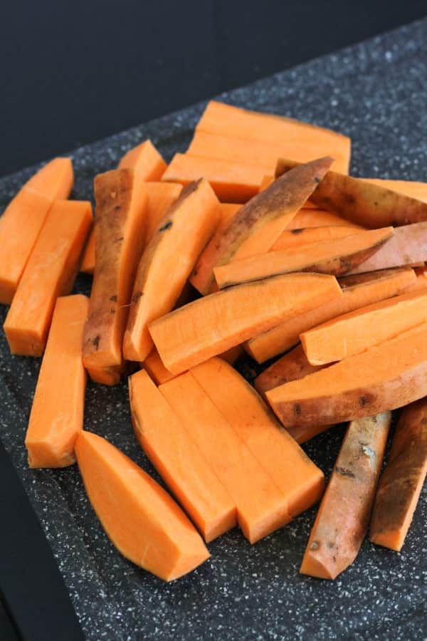 sweet potato wedges on a cutting board.