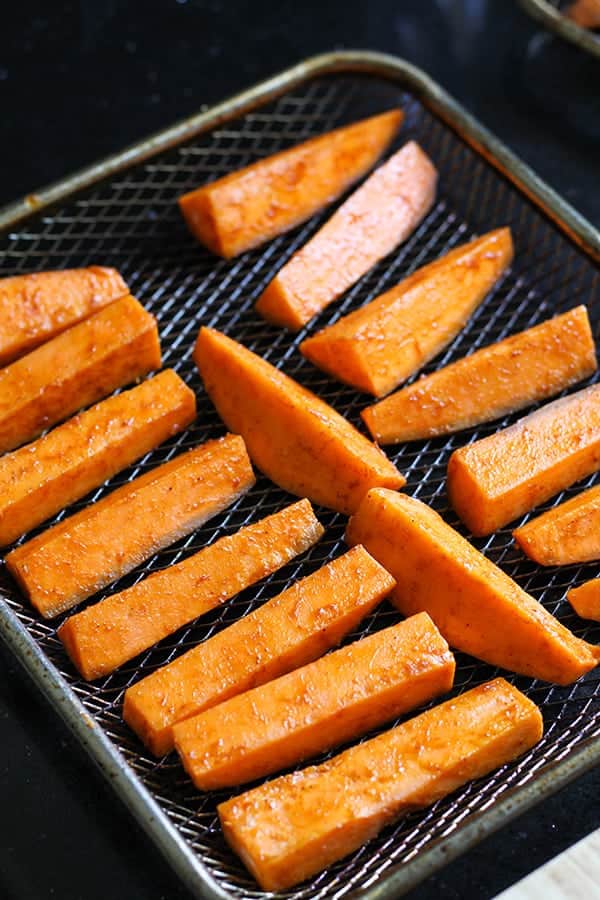 sweet potato wedges on a wire rack.