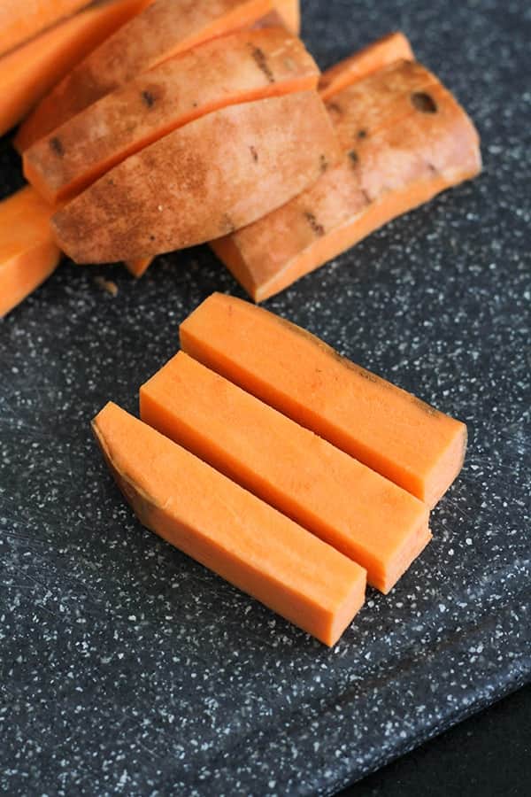 sweet potato wedges on a chopping board.