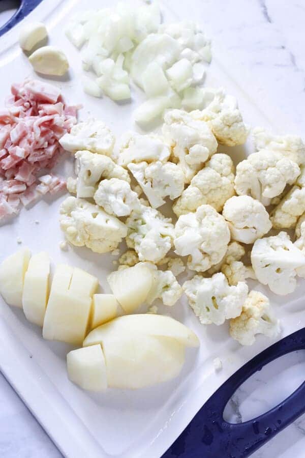 assorted soup ingredients on a chopping board