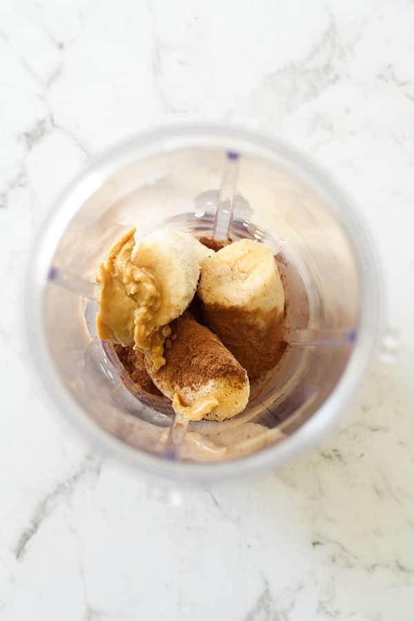 Nice cream ingredients in a blender cup.