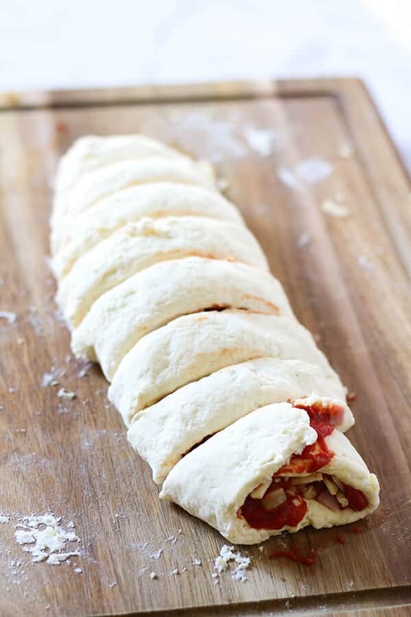 a log of dough cut into 8 pieces.