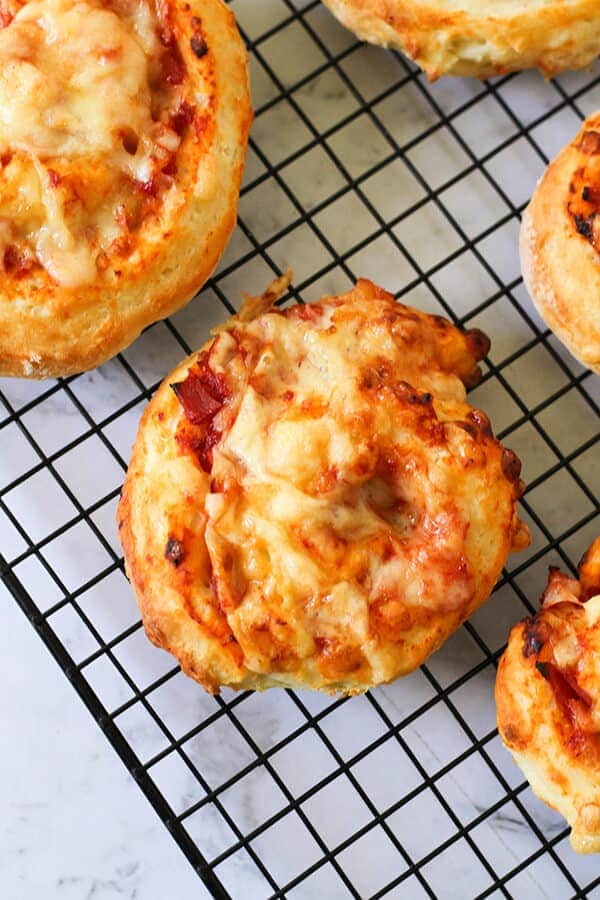 ham and cheese scrolls on a wire cooling rack.