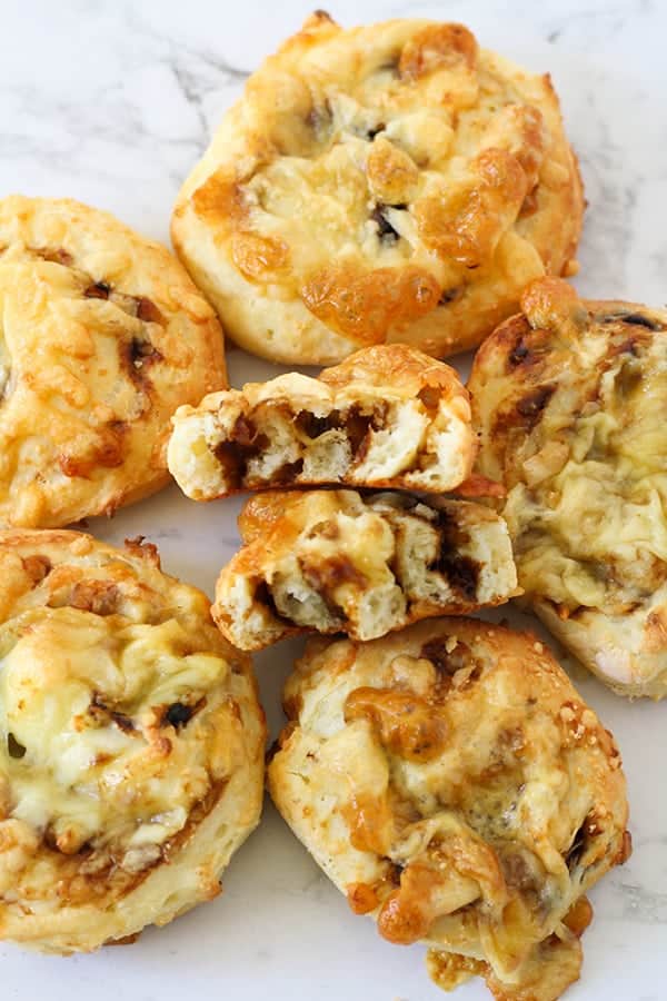 cheesymite scrolls laying on a marble surface.