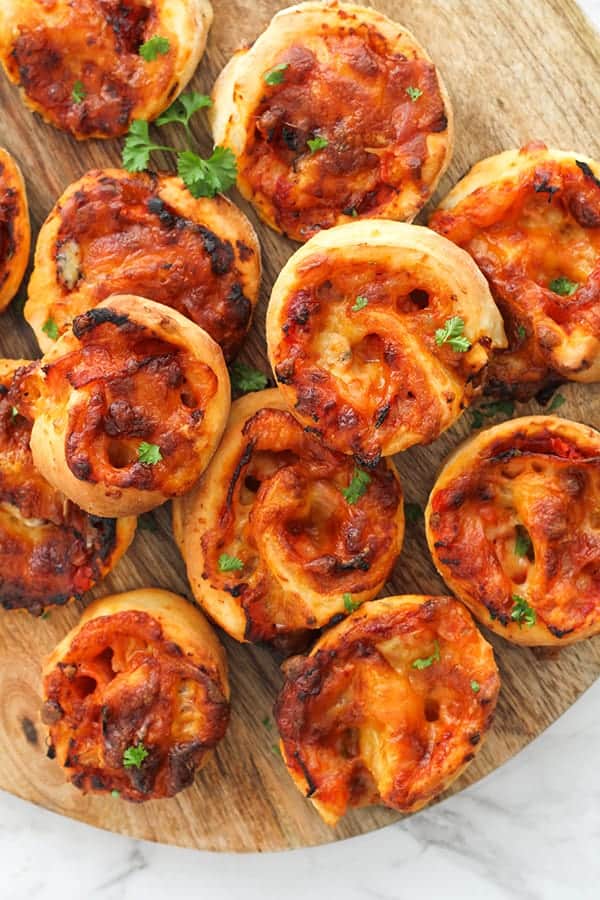 pizza scrolls on a wooden board.