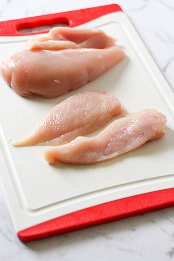 Chicken breast sliced in half.