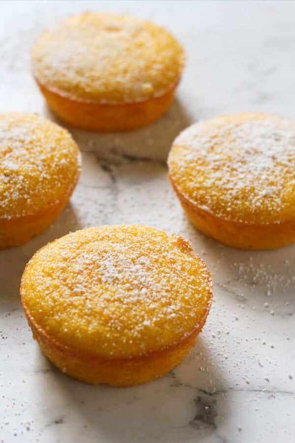 Orange and almond cakes on a marble board.