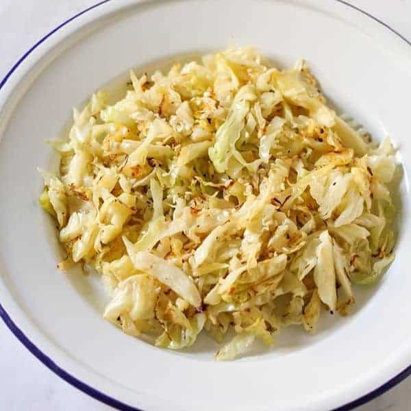 sauteed cabbage in a white bowl.