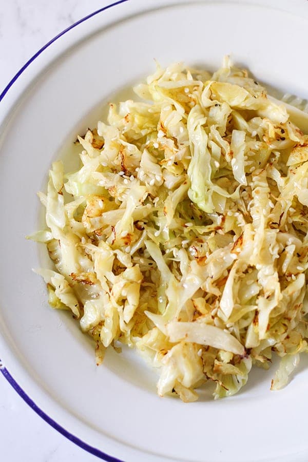 sauteed cabbage in a white bowl.