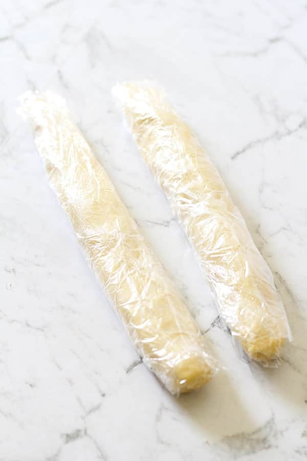 shortbread dough logs wrapped in plastic wrap.