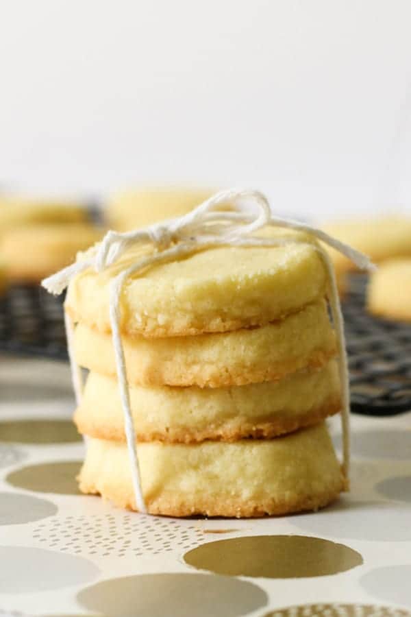 shortbread cookies stacked on top of a wire rack.