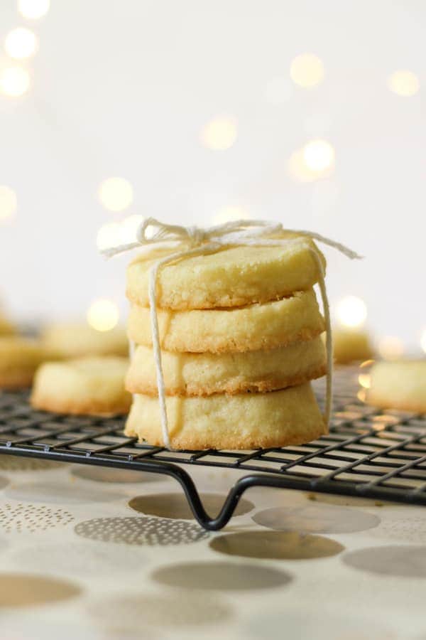 shortbread cookies stacked on top of a wire rack.