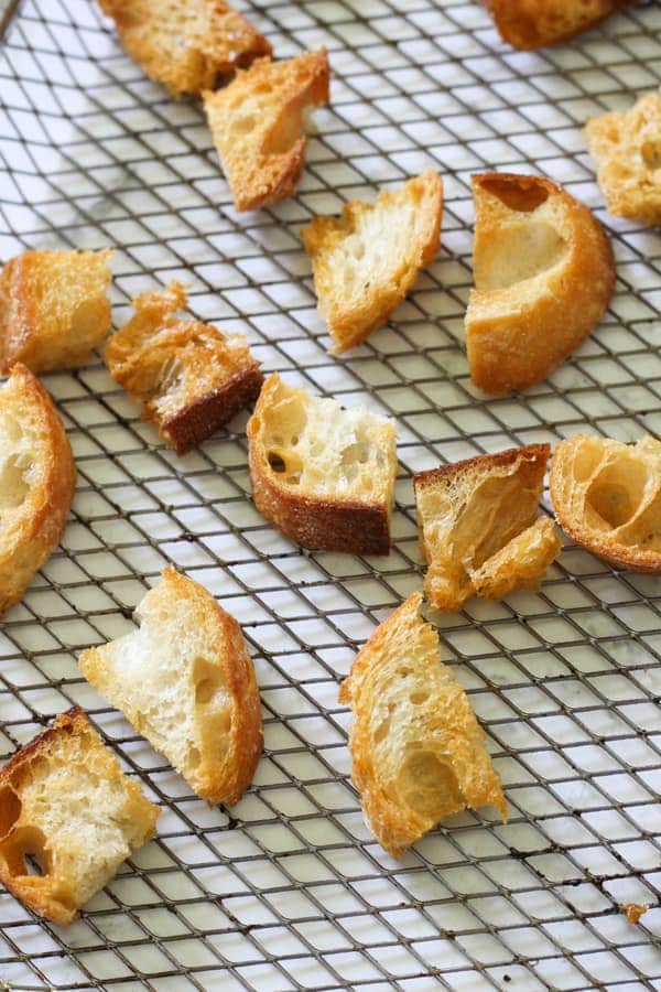 croutons on an air fryer wire rack.